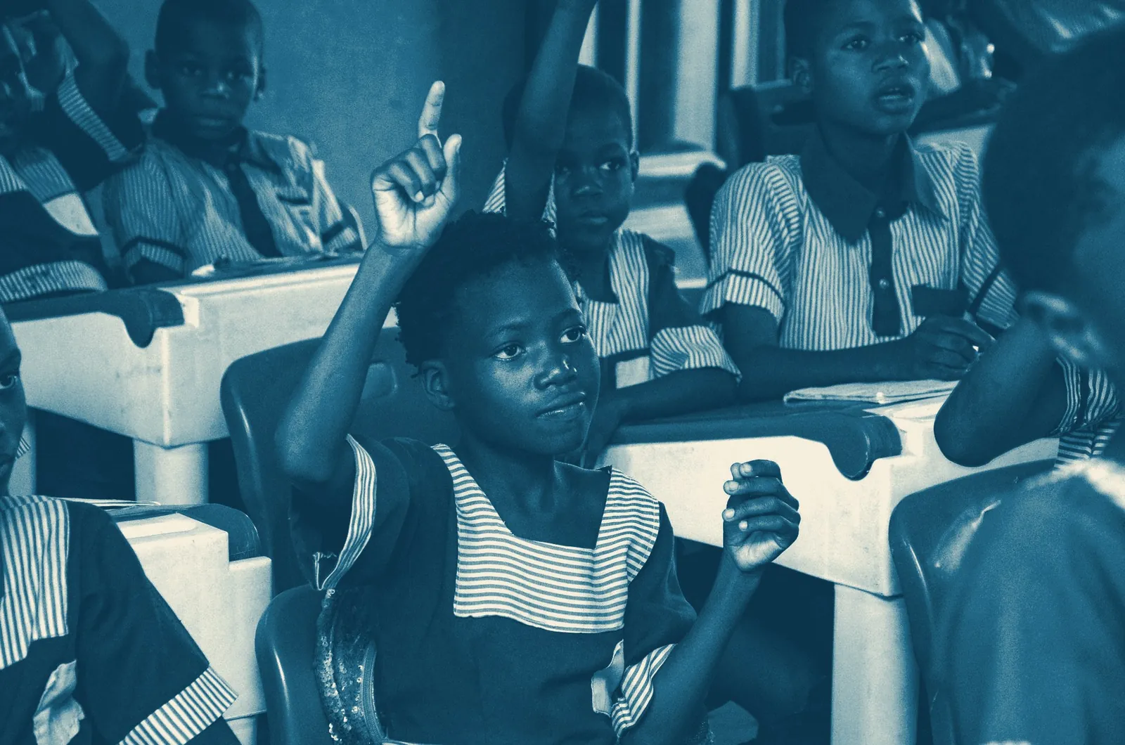 Pupils raising their hands in class