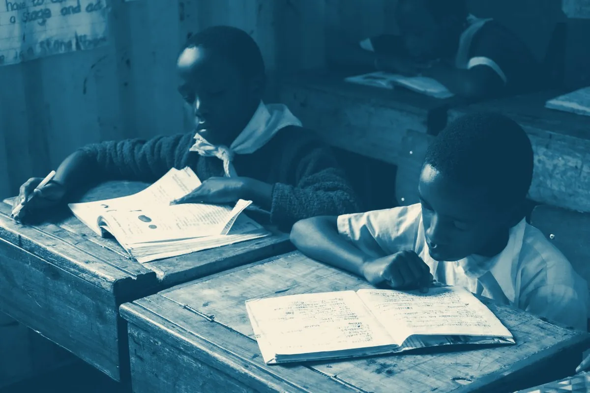 Two pupils reading at a wooden desk